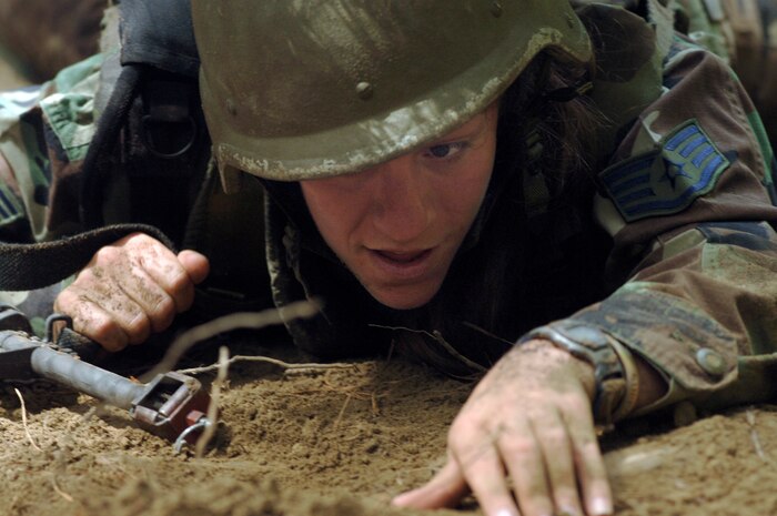 Staff Sgt. Amanda Phillips, 437th Operations Support Squadron intelligence operations analyst, pushes her team through the heat, dirt and sweat as they perform low-crawl movement techniques during Expeditionary Combat Skills Training at Charleston AFB Monday.  (U.S. Air Force photo/ Staff Sgt. April Quintanilla)