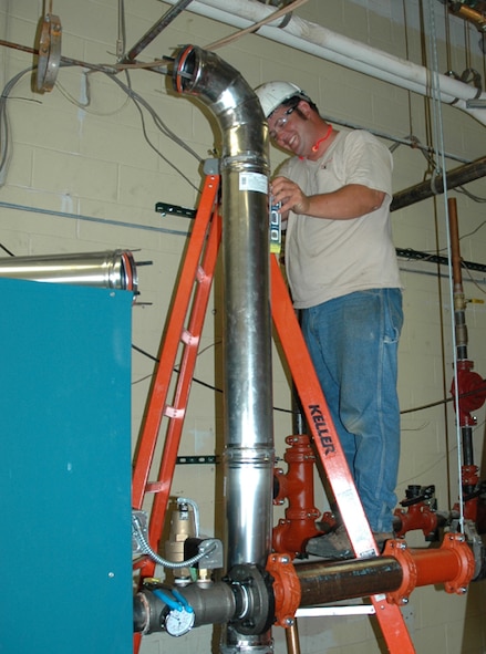 MINOT AIR FORCE BASE, N.D. -- Construction worker Lynn Liferson prepares a utility room at the Shoppette here for installation of a boiler. Minot Air Force Base has begun the process of deactivating its central heat plant and installing individual boilers in 92 buildings across the base in a move to save money and conserve natural gas. (U.S. Air Force photo by Airman 1st Class Wesley Wright)