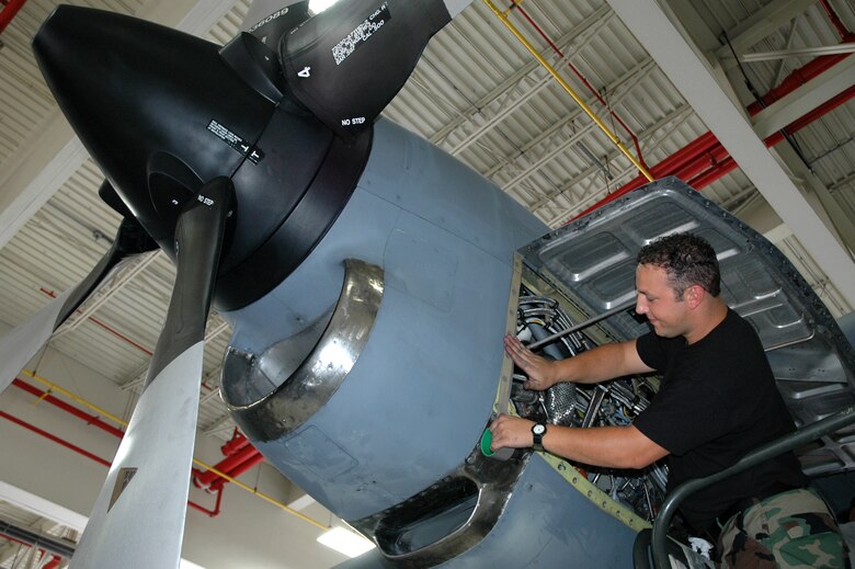 YOUNGSTOWN AIR RESERVE STATION, Ohio - Air Force Reserve Technical Sergeant Frank Serrao, a propulsion craftsman with the 910th Aircraft Maintenance Squadron, applies Teflon tape as a barrier between two metal surfaces to prevent corrosion on the quick exchange panel of a C-130 engine on aircraft 9103 July 18.  Sergeant Serrao is part of a team of about 30 reservists from the 910th Airlift Wing who will compete during Air Mobility Rodeo 2007 July 22-28.  The rodeo focuses on improving our worldwide air mobility forces' professional core capabilities.  More than 40 teams and 2,500 people from the Air Force, Air Force Reserve, as well as allied nations, are expected to participate. The Youngstown team will be the only C-130 competitor from Air Force Reserve Command. U.S. Air Force photo/Tech. Sgt. Bob Barko Jr.