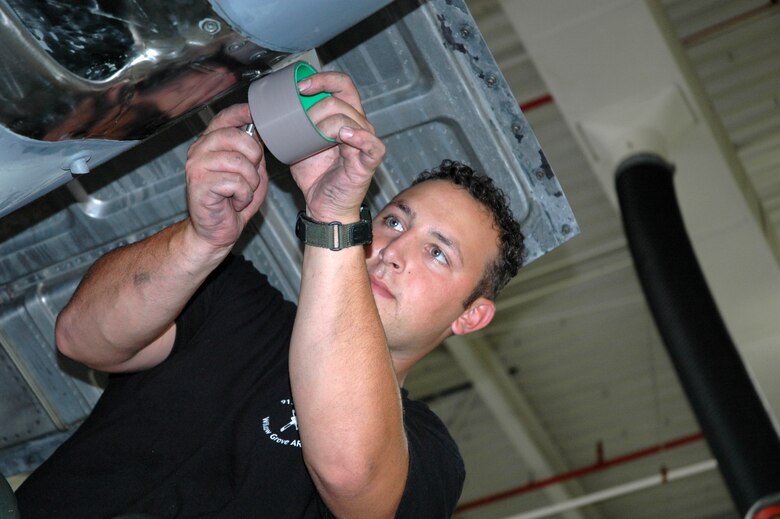 YOUNGSTOWN AIR RESERVE STATION, Ohio - Air Force Reserve Technical Sergeant Frank Serrao, a propulsion craftsman with the 910th Aircraft Maintenance Squadron, applies Teflon tape as a barrier between two metal surfaces to prevent corrosion on the quick exchange panel of a C-130 engine on aircraft 9103 July 18.  Sergeant Serrao is part of a team of about 30 reservists from the 910th Airlift Wing who will compete during Air Mobility Rodeo 2007 July 22-28.  The rodeo focuses on improving our worldwide air mobility forces' professional core capabilities.  More than 40 teams and 2,500 people from the Air Force, Air Force Reserve, as well as allied nations, are expected to participate. The Youngstown team will be the only C-130 competitor from Air Force Reserve Command. U.S. Air Force photo/Tech. Sgt. Bob Barko Jr.
