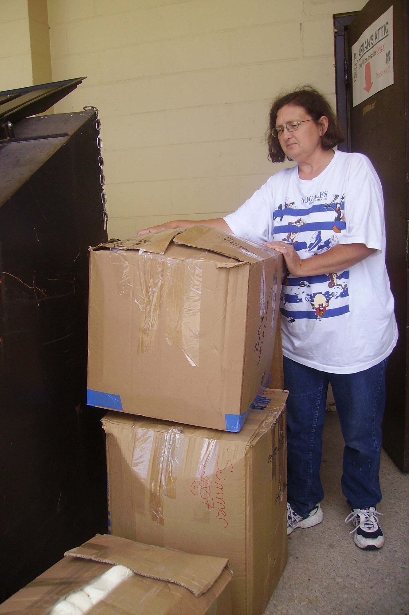 Tina Shreve, Airman’s Attic volunteer, arranges boxes dropped off at the Airman’s Attic collection point July 13. An influx of boxes and large items have caused the Attic to be closed. Once items are rounded up, they are taken into the store where they are prepared to provide to Airmen and their families. Customers are reminded to donate only items that are in good condition or that have been gently used. (U.S. Air Force photo/Staff Sgt. Rob Hazelett)