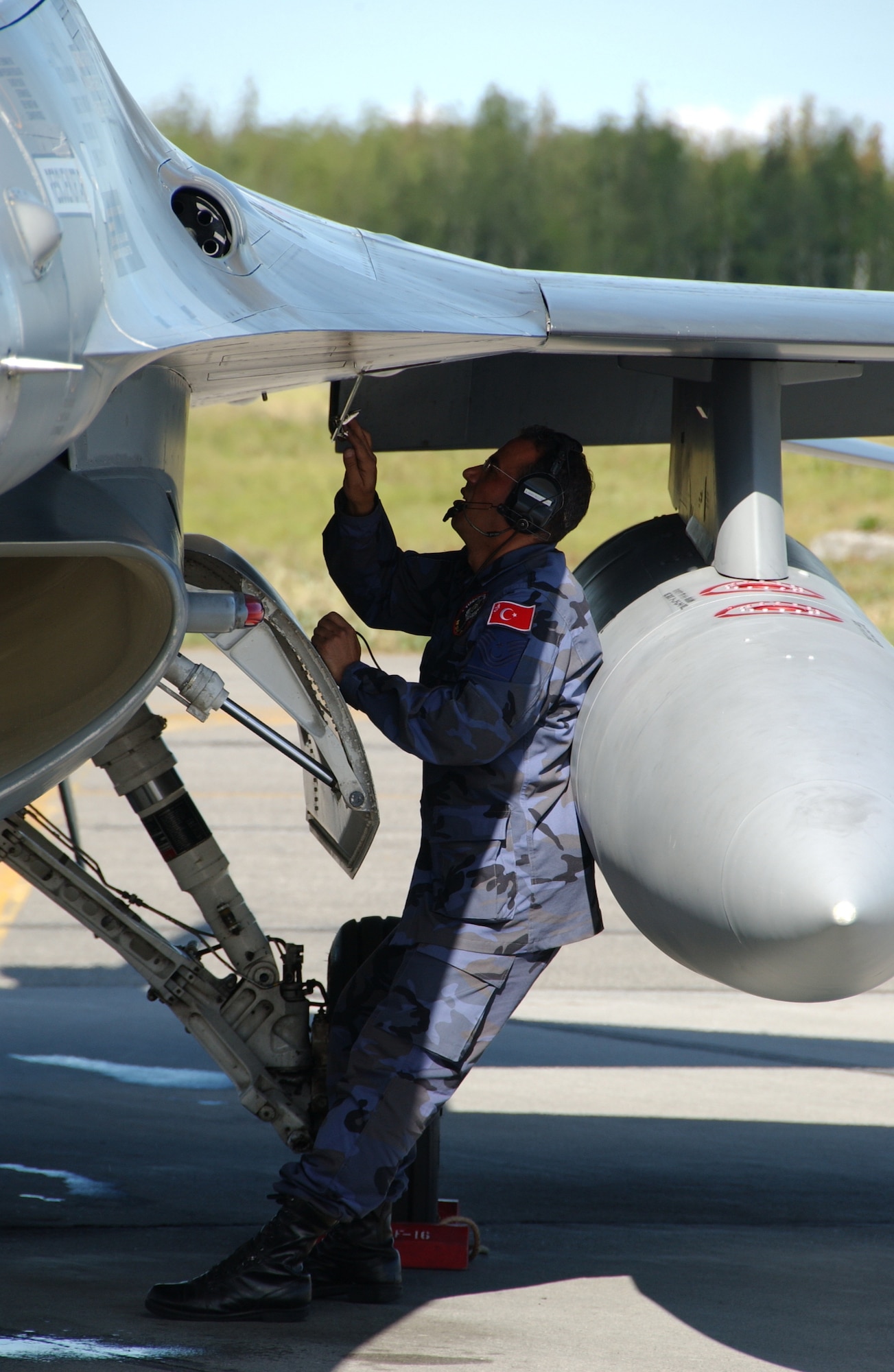 EIELSON AIR FORCE BASE, Alaska --  Master Sgt. Adnan Akpinar, Turkish Air Force, conducts a maintenance check on the exterior of an F-16C before taking off to participate in Red Flag-Alaska July 16, 2007. Red Flag-Alaska provides training for deployed maintenance and support personnel in sustainment of a large-force deployed air operation.(U.S. Air Force photo by Airman 1st Class Christopher Griffin) 