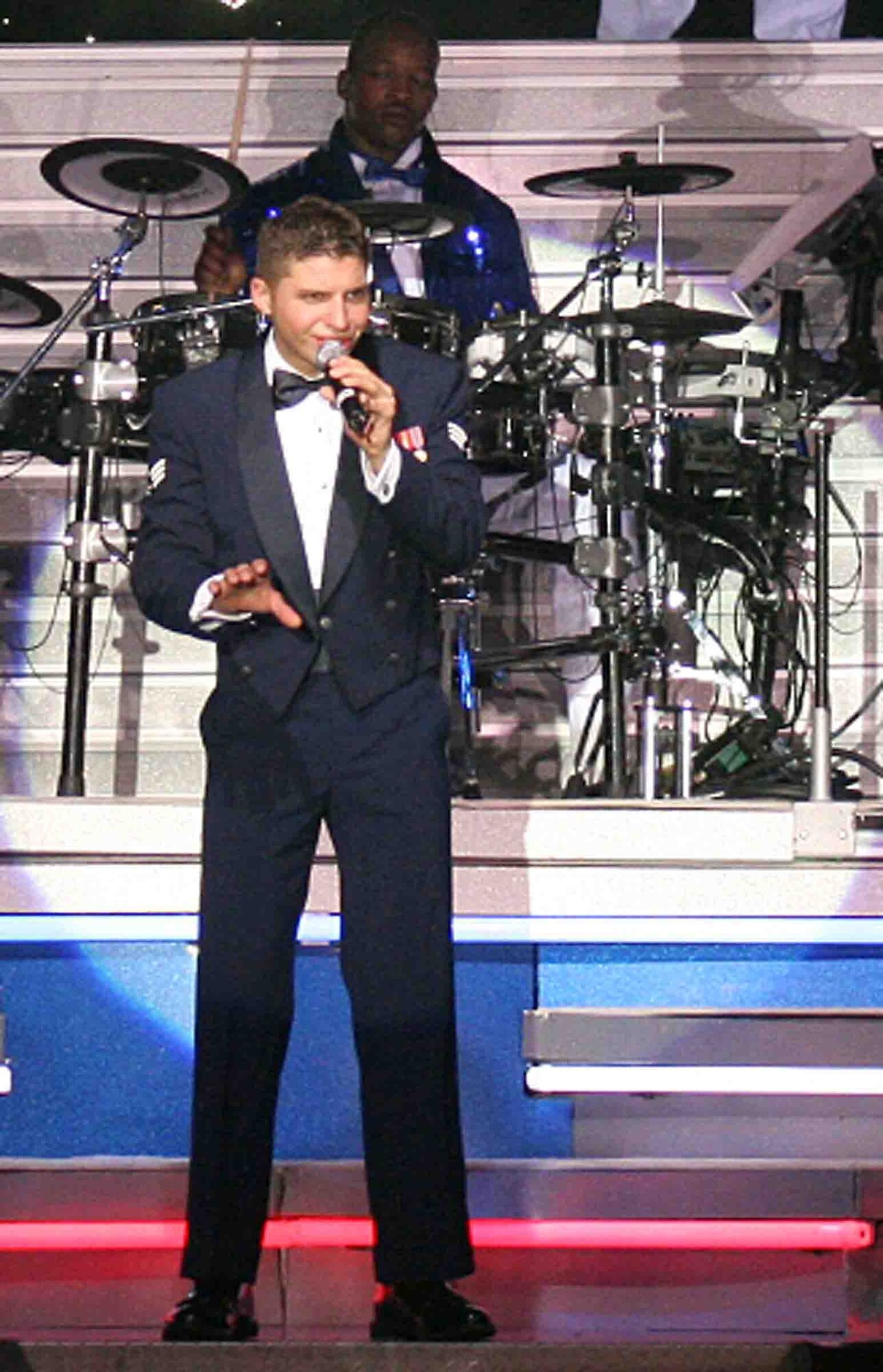 LAJES FIELD, Azores, Portugal -- Senior Airman Jonathan Hayden, Tops In Blue vocalist, sings during a performance July 14. Tops In Blue visited Lajes in their first of six performances at European installations as part of a team of 40 vocalists, musicians, dancers and technicians on a 27-country, 140-performance tour commemorating the Air Force's 60th anniversary. Airman Hayden is a telephone switching maintenance technician from the 609th Air Communications Squadron at Shaw Air Force Base, S.C. Tops in Blue is scheduled to perform in Sumter, S.C., Oct. 4. (U.S. Air Force photo/Tech. Sgt. Edgar Barbosa)