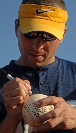 Ramon Scribner, 437 LRS, signs the winning ball.(U.S. Air Force Photo/Staff Sgt. April Quintanilla)