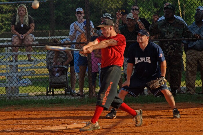 Joseph Fournier, 437 CES, smashes the ball to the outfield.(U.S. Air Force Photo/Staff Sgt. April Quintanilla)