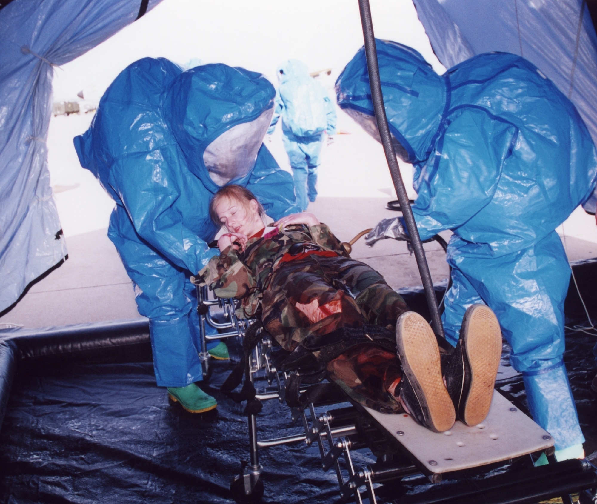 Tinker personnel decontaminate a “victim” during a recent weapons of mass destruction exercise involving outside agencies. Adopting the Air Force Incident Management System, based on the National Incident Management System and National Response Plan, now allows Tinker emergency responders to better communicate with their civilian counterparts in a crisis situation. (Air Force photo)