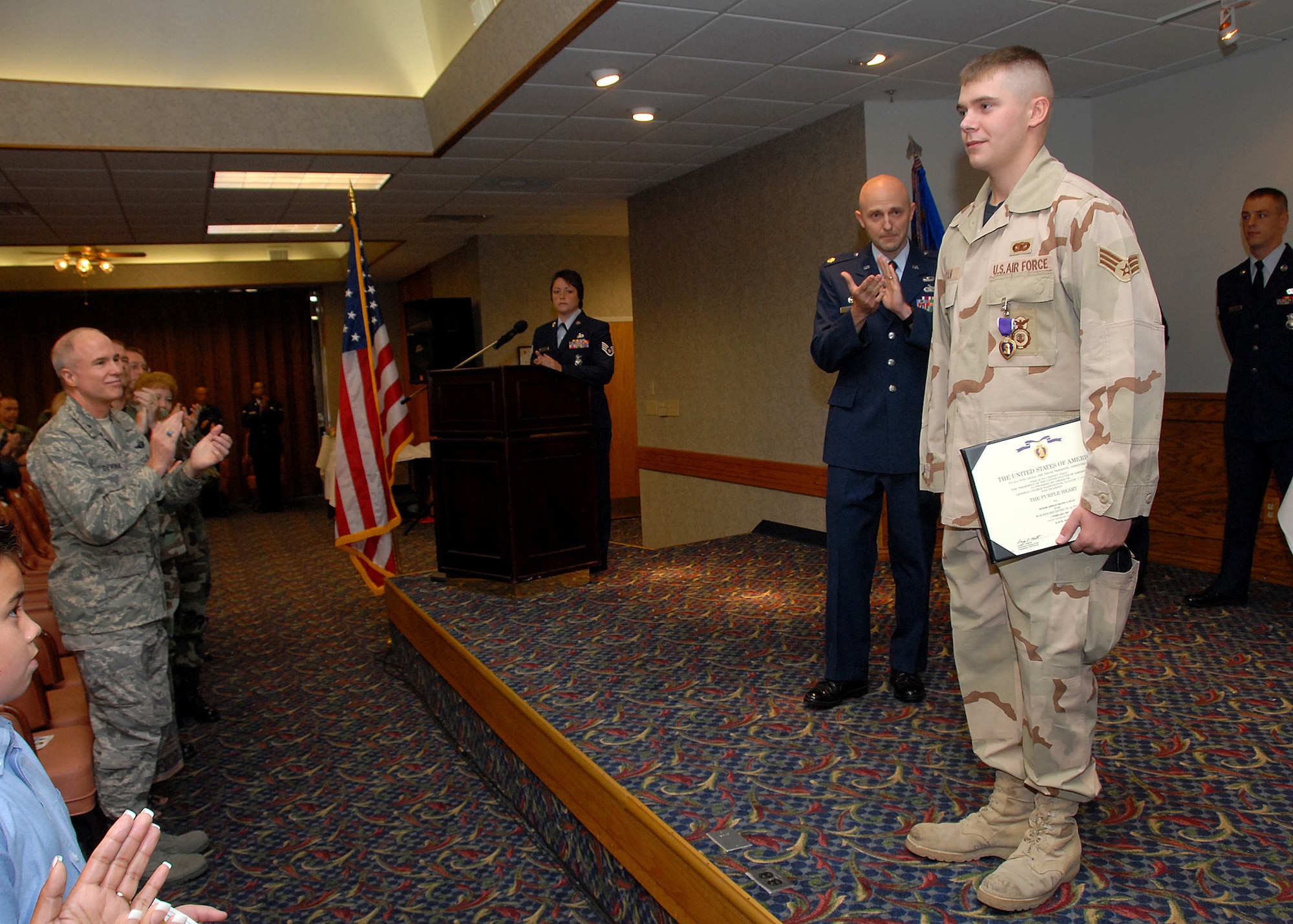 Senior Airman Shawn Ryan, 82nd Security Forces Squadron, recieves his Purple Heart for injuries sustained while deployed to Iraq, July 16 at the Sheppard Club. (U.S. Air Force photo Mike Litteken)