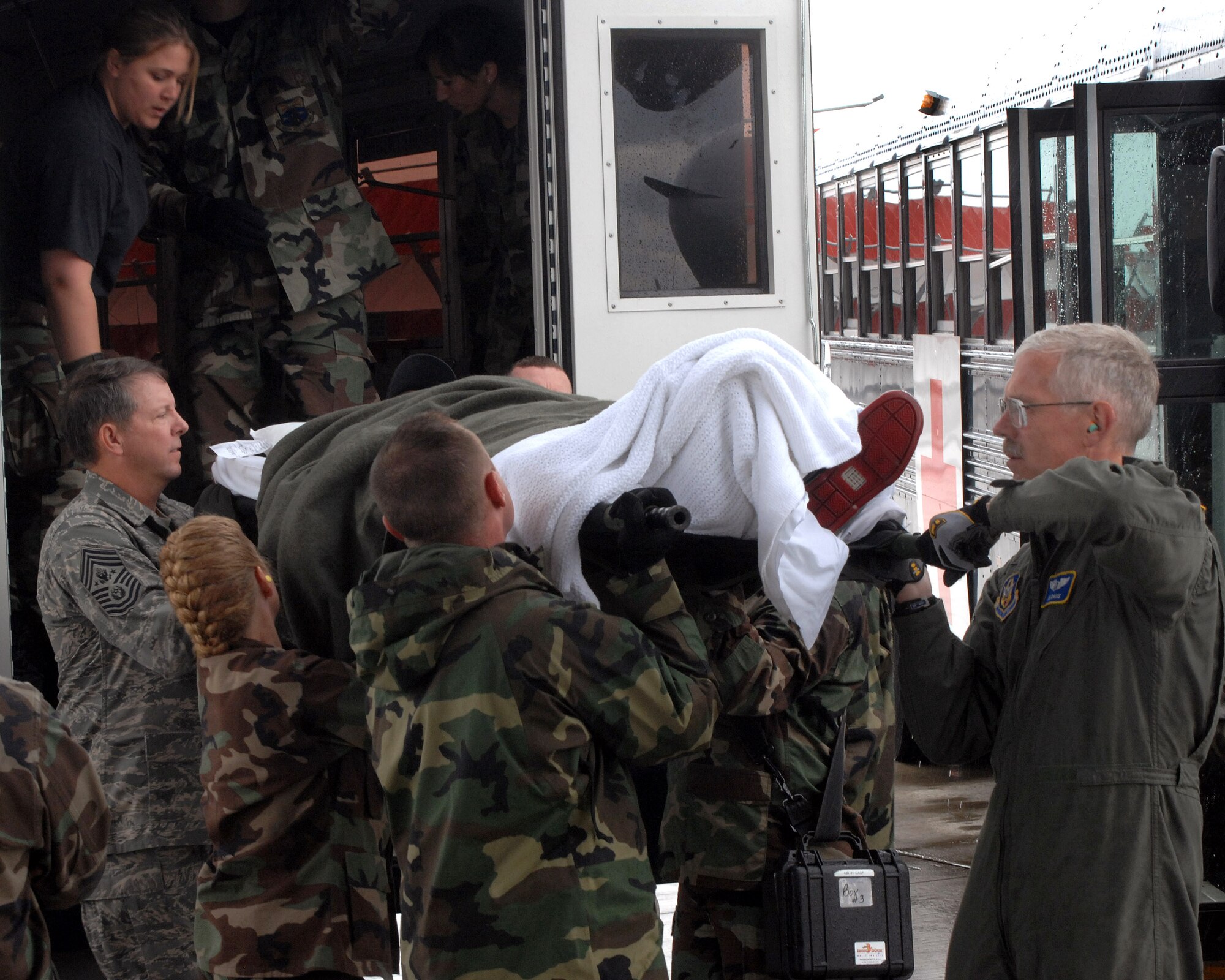 Chief Master Sgt. of the Air Force Rodney J. McKinley and members of the 435th Aerospace Medicine Squadron help load a patient going onto an aeromedical evacuation flight July 10 at Ramstein Air Base, Germany. Chief McKinley followed patients through Landstuhl Regional Medical Center to the Contingency Areomedical Staging Facility and finally on the flight back to the states. (U.S. Air Force photo/Airman 1st Class Kenny Holston)