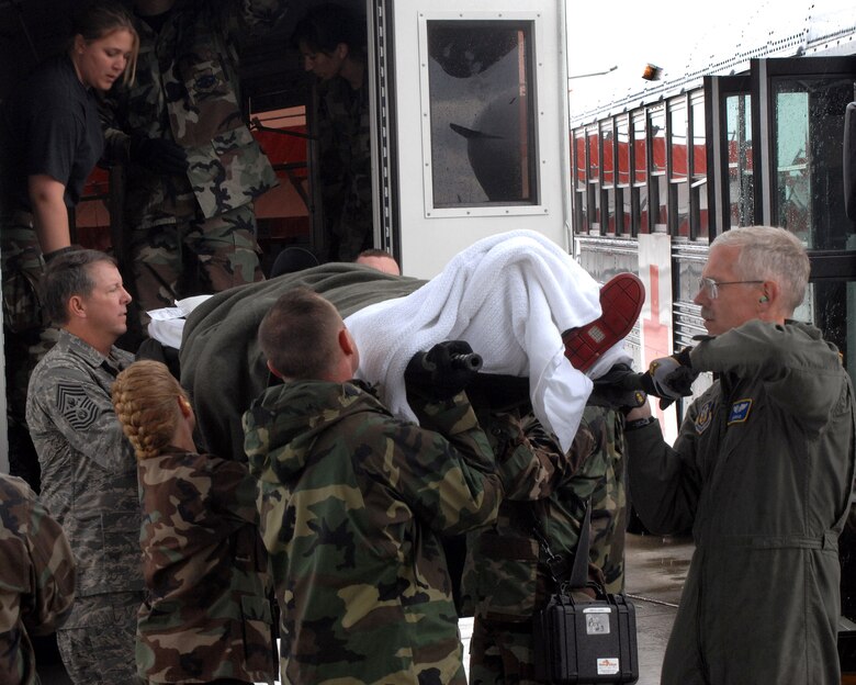 Chief Master Sgt. of the Air Force Rodney J. McKinley and members of the 435th Aerospace Medicine Squadron help load a patient going onto an aeromedical evacuation flight July 10 at Ramstein Air Base, Germany. Chief McKinley followed patients through Landstuhl Regional Medical Center to the Contingency Areomedical Staging Facility and finally on the flight back to the states. (U.S. Air Force photo/Airman 1st Class Kenny Holston)