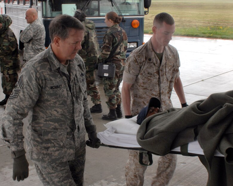 Chief Master Sgt. of the Air Force Rodney J. McKinley and Marine Staff Sgt. Jason McIntee help load a patient going onto an aeromedical evacuation flight July 10 at Ramstein Air Base, Germany. Chief McKinley followed patients through Landstuhl Regional Medical Center to the Contingency Areomedical Staging Facility and finally on the flight back to the states. (U.S. Air Force photo/Airman 1st Class Kenny Holston)

