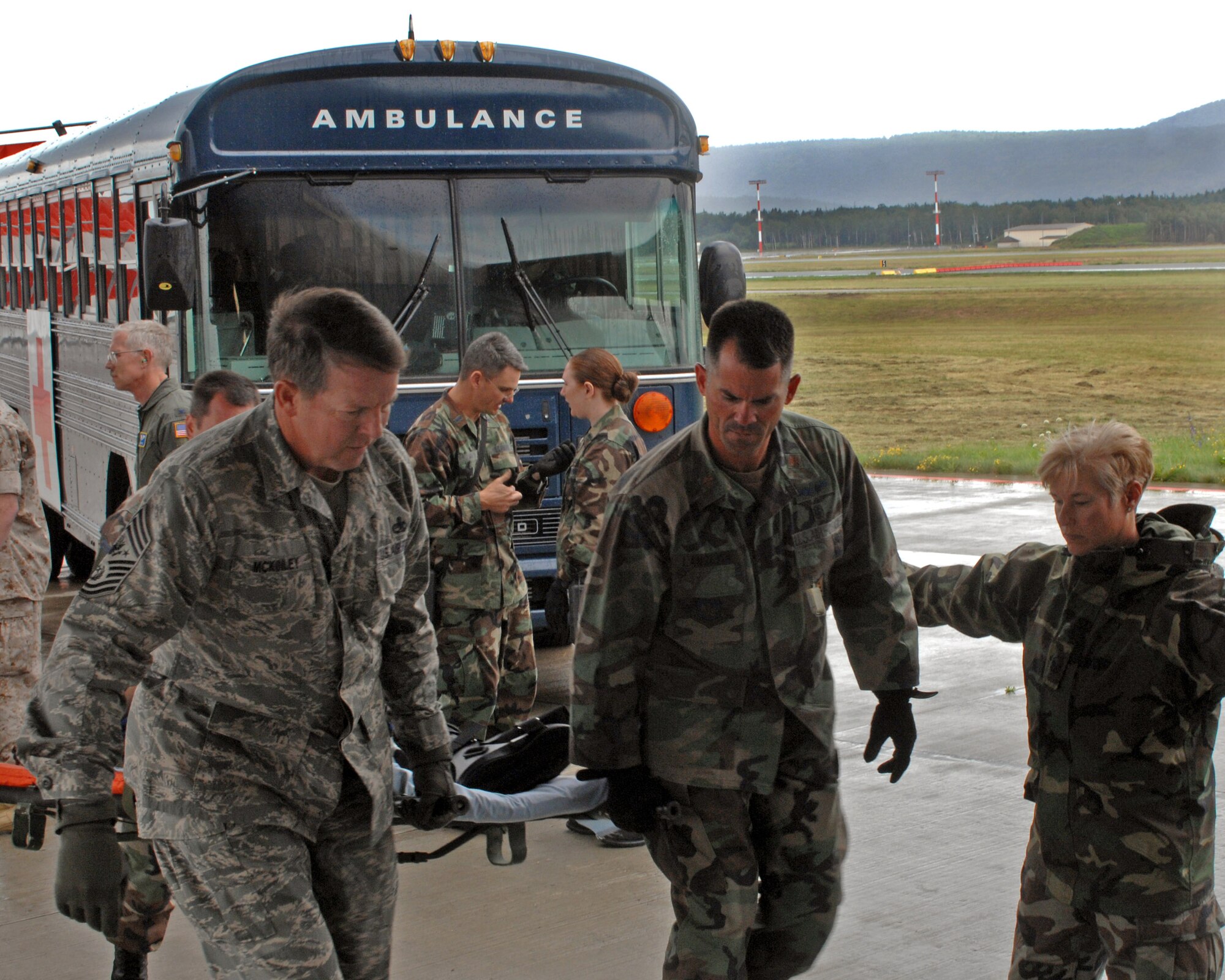 Chief Master Sgt. of the Air Force Rodney J. McKinley and Maj. Paul Langevin help load a patient onto an aeromedical evacuation flight July 10 at Ramstein Air Base, Germany. Chief McKinley followed patients through Landstuhl Regional Medical Center to the Contingency Areomedical Staging Facility and finally on the flight back to the states. Major Langevin is with the 435th Aerospace Medicine Squadron. (U.S. Air Force photo/Airman 1st Class Kenny Holston)