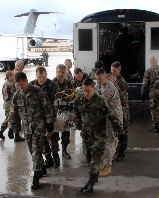 Areomedical evacuation flight members and 435th Aerospace Medicine Squadron members help load a patient onto an aeromedical evacuation flight July 10 at Ramstein Air Base, Germany.  (U.S. Air Force photo/Airman 1st Class Kenny Holston)