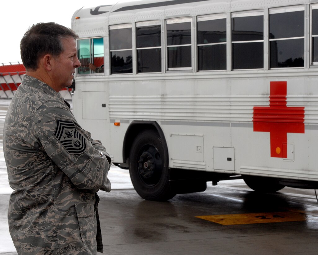 Chief Master Sgt. of the Air Force Rodney J. McKinley waits for a medical bus full of wounded Airmen and Soldiers so he can help load patients onto an aeromedical evacuation flight July 10 at Ramstein Air Base, Germany. Chief McKinley followed patients through Landstuhl Regional Medical Center to the Contingency Areomedical Staging Facility and finally on the flight back to the states. (U.S. Air Force photo/Airman 1st Class Kenny Holston)