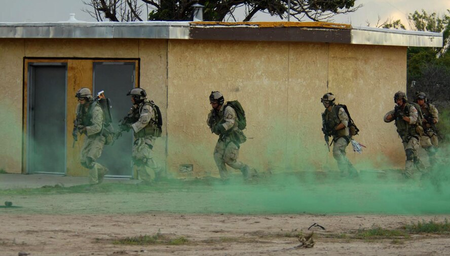 Pararescuemen from the 58th Rescue Squadron at Nellis Air Force Base, Nev., move in to rescue simulated survivors during a training scenario July 13 at Playas, N.M., that is part of Exercise Angel Thunder 2007.  Angel Thunder is a combat search and rescue task force exercise designed to test theater spin-up capabilities and examine the integration of all Air Force assets in mission planning procedures and mission execution.  (U.S. Air Force photo/Senior Airman Christina D. Ponte)