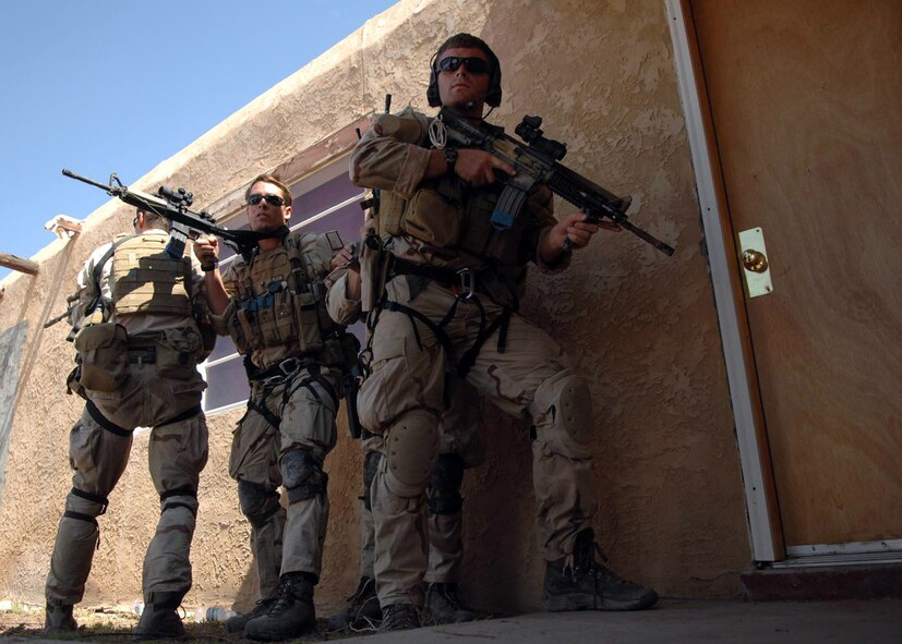 Pararescuemen from the 58th Rescue Squadron at Nellis Air Force Base, Nev., prepare to enter an abandoned house during a training scenario July 13 at Playas, N.M., that is part of Exercise Angel Thunder 2007.  Angel Thunder is a combat search and rescue task force exercise designed to test theater spin-up capabilities and examine the integration of all Air Force assets in mission planning procedures and mission execution.  (U.S. Air Force photo/Senior Airman Christina D. Ponte)