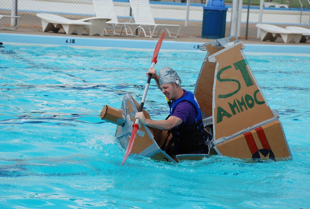 2nd Lt. Jeffery Fry, 360th Training Squadron aircraft maitenance officers course student, fights to keep his vessel afloat during the annual Build-a-Boat Race July 14 at the main pool. (U.S. Air Force photo/Airman 1st Class Jacob Corbin)