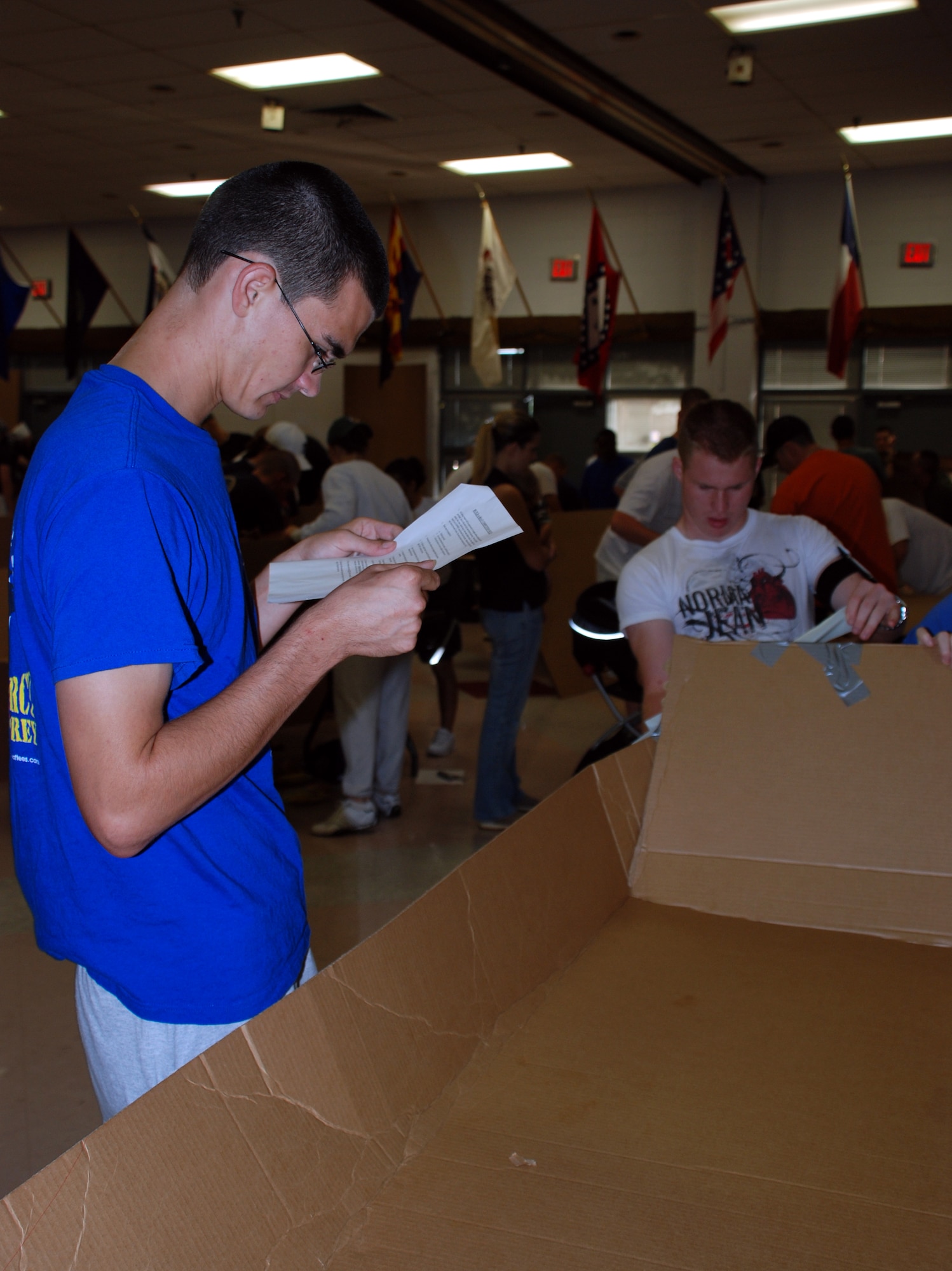 Airman Basic Derick Finker and Airman Basic Joshua Bybee, both Airman-in-Training with the 362nd Training Squadron, work on their teams vessel during the annual Build-a-Boat Race July 14 at the main pool. (U.S. Air Force photo/Airman 1st Class Jacob Corbin) 