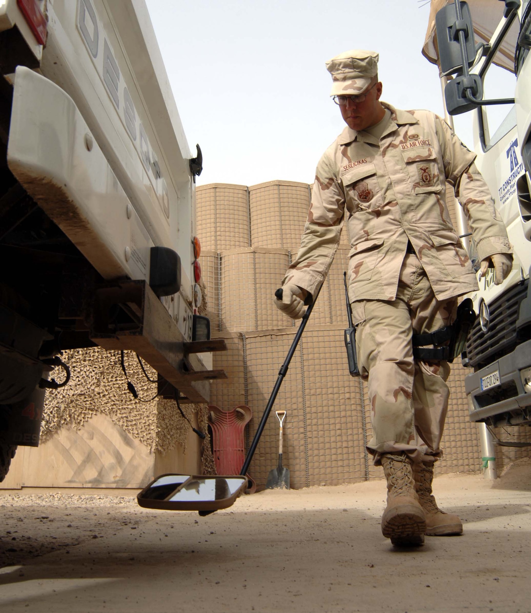 SATHER AIR BASE, Iraq - Senior Airman Felix Sereicikas, 447th Expeditionary Security Forces Squadron, searches for suspicious items in the undercarriage of a truck at the Sierra-three Search Pit on the north end of Sather. Also known as the “Scorpion Pit” the security forces Airmen assigned there process more than 600 vehicles and 2,000 people weekly. (U.S. Air Force photo/Tech. Sgt. Russell Wicke)