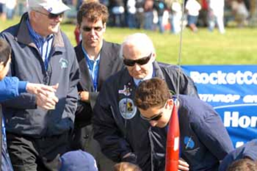 Secretary of the Air Force Michael Wynne; Col. Buzz Aldrin, USAF (Ret.) (back to camera); Mark Esper, AIA Executive Vice President, Defense & International Affairs and members of the 2007 winning team from Newark Memorial High School, Newark, California at th