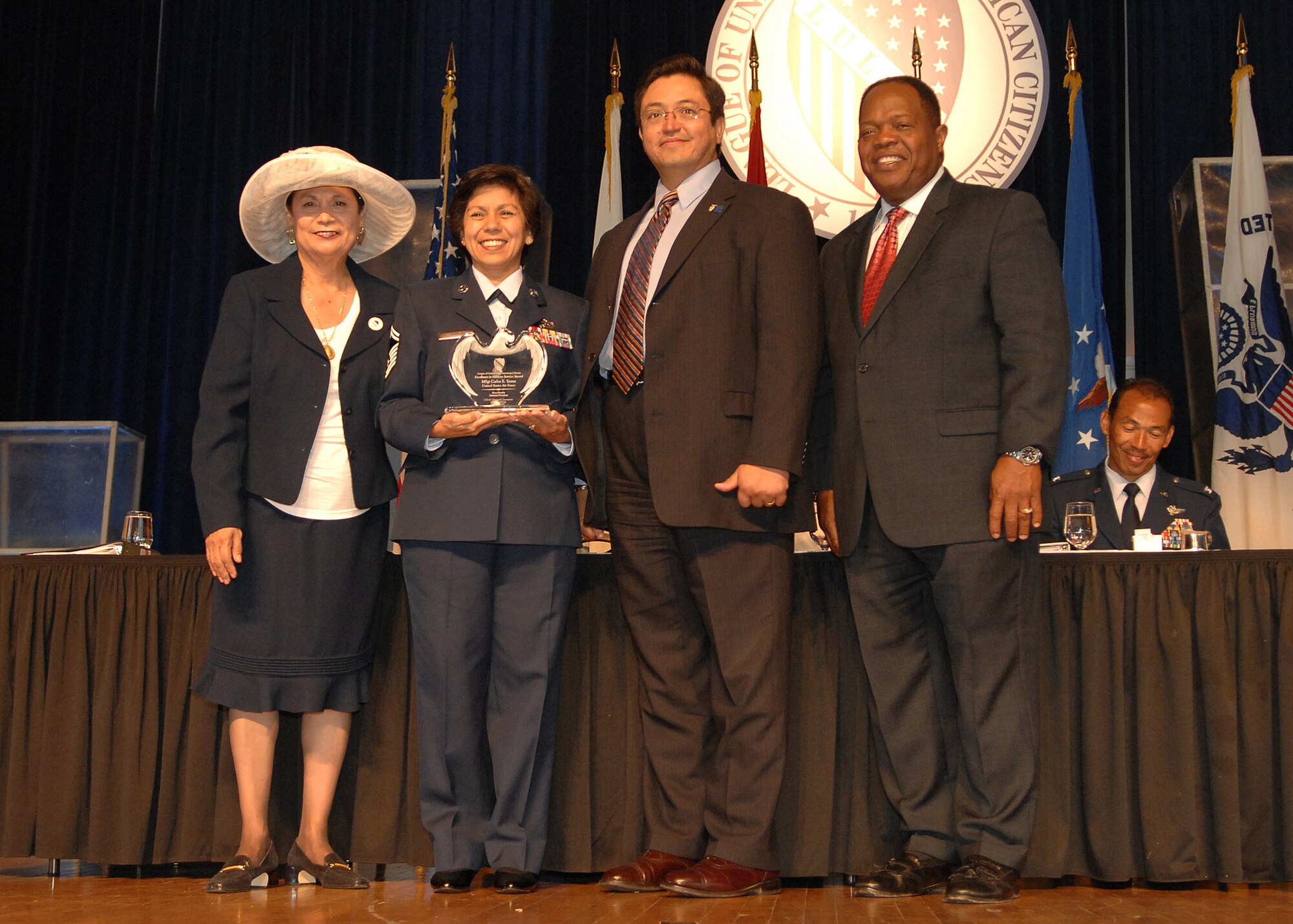 Senior Master Sgt. Angelita Ramirez Thayer, a reservist from McChord Air Force Base, Wash., recieves the "Excellence in Military Service Award" from left to right, Rosa Rosales, national president, League of United Latin American Citizens , Joseph M. Guzman, deputy assistant secretary for Strategic Diversity Immigration, Pentagon, and Clarence A. Johnson, principal director, Office of Diversity Management and Equal Opportunity during the 78th LULAC National Convention and Exposition in Chicago, July 12. LULAC convenes the national delegates to discuss the positions, strategies, and outreach programs of the national Hispanic organization. Founded in 1929, LULAC is the nation's oldest and largest Hispanic organization. (U.S. Air Force photo/SSgt Stephen Schester)