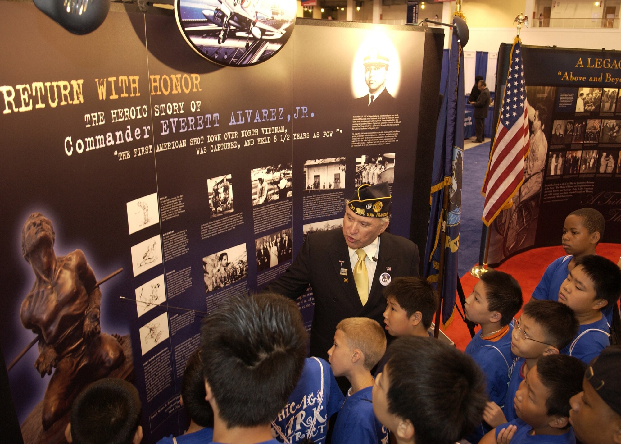 Rick Leal, president of the Hispanic Medal of Honor Society in San Francisco, Calif., talks with youths about the first American shot down over North Vietnam, Commander Everett Alvarez, Jr., at the 78th League of United Latin American Citizens National Convention and Exposition in Chicago,  July 11. LULAC convenes the national delegates to discuss the positions, strategies, and outreach programs of the National Hispanic Organization. Founded in 1929, LULAC is the nation's oldest and largest Hispanic organization. (U.S. Air Force photo/Staff Sgt Stephen Schester) 