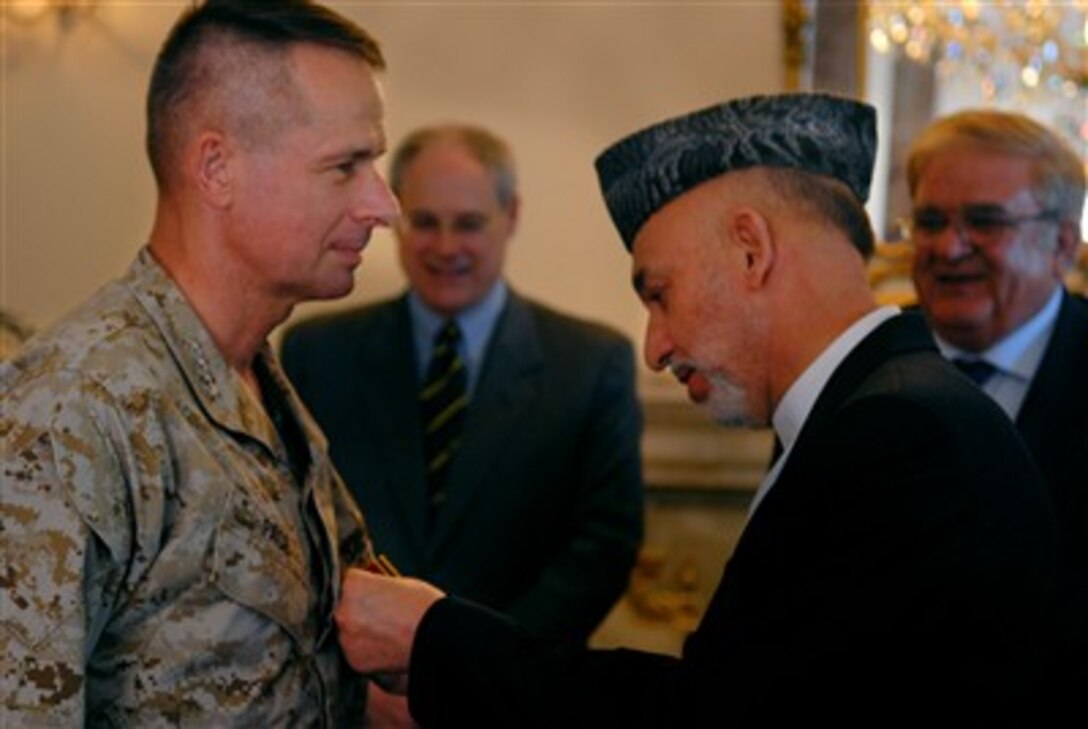 President of Afghanistan Hamid Karzai presents Chairman of the Joint Chiefs of Staff U.S. Marine Gen. Peter Pace the highest award given to non-Afghans in Kabul, Afghanistan, July 18, 2007. Karzai thanked Pace for all he's done to help the Afghan people. 