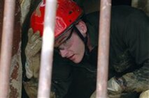 Lance Cpl. Jonathan Heale, an identification and detection specialist with CBIRF’s Identification and Detection Platoon, exits a collapsed structure at the CBIRF Basic Operations Course. This is the final practical application for Marines and Sailors to graduate the course. Senior enlisted, officers and key billet holders go on to the advanced course for follow-up training in consequence management.