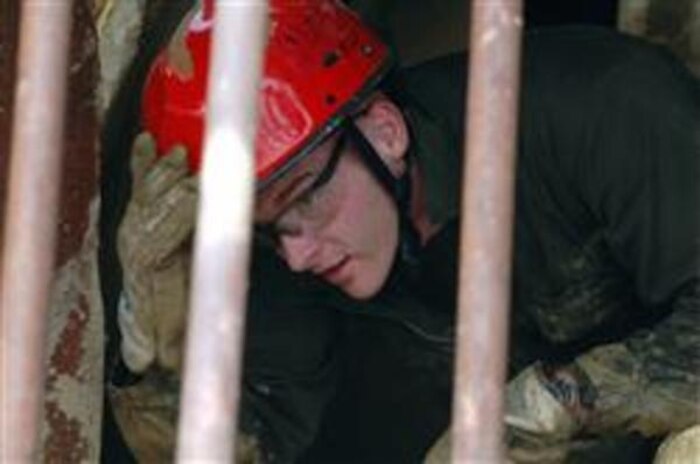 Lance Cpl. Jonathan Heale, an identification and detection specialist with CBIRF’s Identification and Detection Platoon, exits a collapsed structure at the CBIRF Basic Operations Course. This is the final practical application for Marines and Sailors to graduate the course. Senior enlisted, officers and key billet holders go on to the advanced course for follow-up training in consequence management.