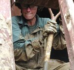 Navy Lt. Cmdr. Pamela Krahl, an occupational health provider and senior medical officer with Medical Platoon, Chemical Biological Incident Response Force, II Marine Expeditionary Force, clears mud away from an entrance to a collapsed structure during CBIRF Basic Course here July 19. Marines and sailors maneuver through the collapsed structure to extract simulated casualties.