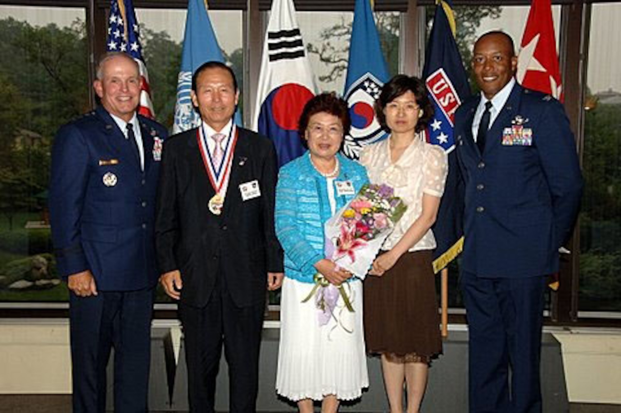 YONGSAN GARRISON, Republic of Korea -- Lieutenant Gen. Stephen Wood, 7th Air Force commander, stands with Gunsan City Mayor Moon, Dong Shin, July 18 at the Dragon Hill Lodge here. Mayor Moon received a good neighbor program award for his friendship and support to Kunsan Air Base. Colonel CQ "Wolf" Brown, (Far right) 8th Fighter Wing commander, accompanied Mayor Moon, his wife and daughter to the dinner and awards ceremony. (U.S. Army photo/Sgt. 1st Class Horacio Lozano) 
