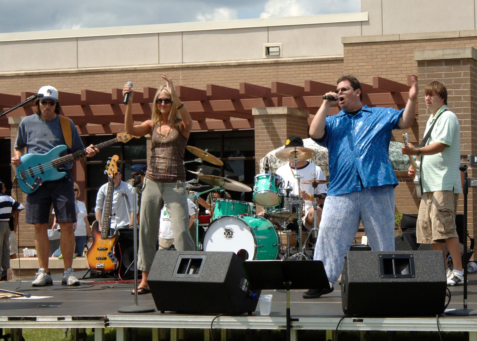 “Big Fat Fun” band members Tommy McClure, guitar player, April Turner, vocalist, Tom Henry, drummer, Jason Shire, lead vocals and Dave Keller, base guitar player, perform July 13 at McConnell’s Open House picnic at the Robert J. Dole Community Center. The base held the picnic to honor military members and their families. Approximately 1,800 people attended the event. The picnic featured several aerial demonstrations including performances from the F-16 Viper West Team, the Navy Blue Angels, and the Army Golden Knights. (Photo by Airman 1st Class Roy Lynch)