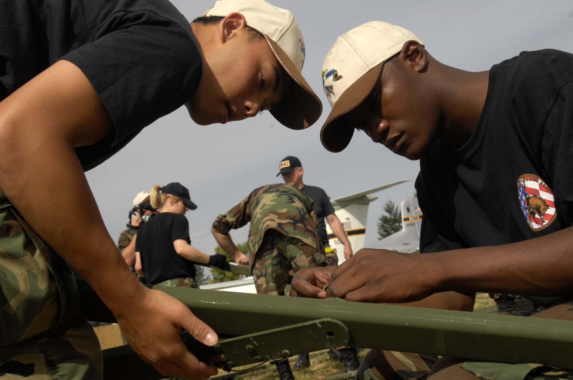 Members of the "Wranglers" put up a tent on July 16, 2007, during Rodeo 2007, hosted by Air Mobility Command. Rodeo is a readiness competition of U.S. and international mobility air forces. It focuses on improving warfighting capabilities and support of the Global War on Terrorism. (U.S. Air Force photo by Staff Sgt. Richard Rose) 