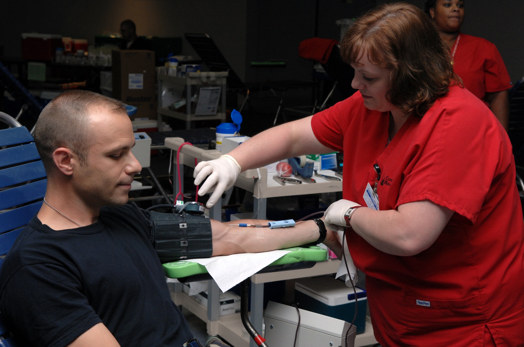 WHITEMAN AIR FORCE BASE, Mo. -- Grace Gibony, a phlebotomist for the Community Blood Center monitors Maj. Ryan Girrbach, 509th Medical Group, as he gives blood at the community activities center July 19. The Community Blood Center distributes 550 pints of blood a day to more than 70 hospitals in the area. Blood is tested within 24 hours of donation and sent to a hospital within 48 hours. It has a shelf life of 42 days. Blood collected by the Community Blood Center is used within five days of collection, according to Carolyn Garner, a Community Blood Center representative. (U.S. Air Force photo/Airman 1st Class Stephen Linch)