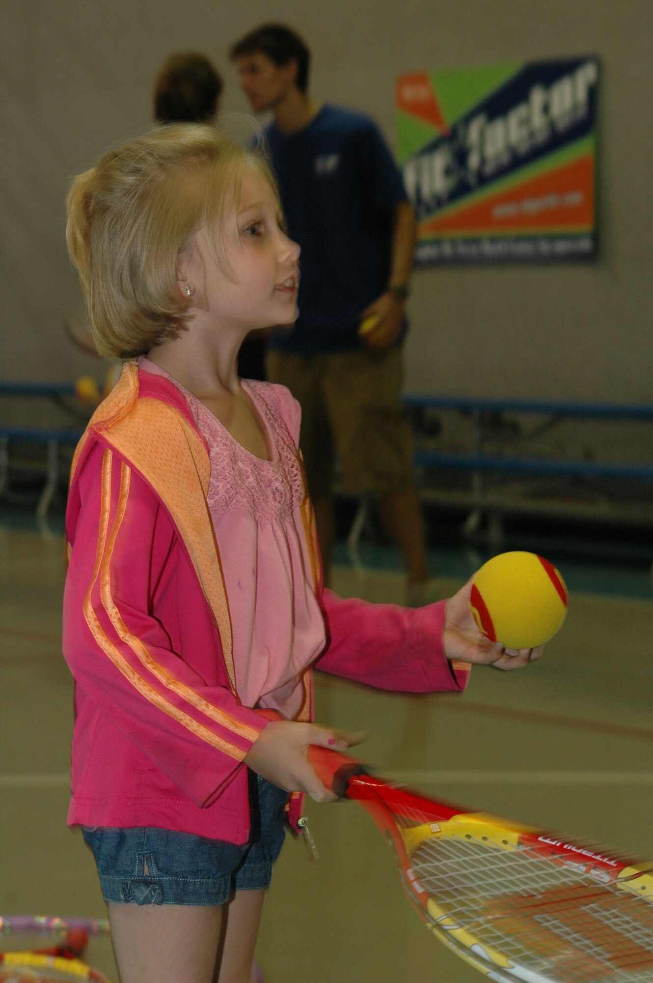 Little Warrior Amber, 7, practices bouncing techniques at  the tennis clinic at the Youth Programs Center June 27. (U.S. Air Force photo / Airman 1st Class Dillon White)