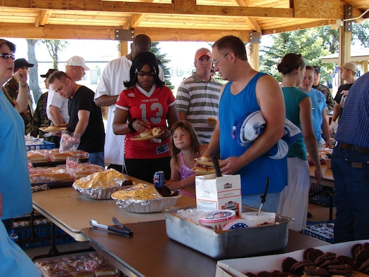 Community members fill their plates in the food tent. This year’s event is July 27 from 
11 a.m. to 3 p.m. (U.S. Air Force photo / Valerie Mullett)