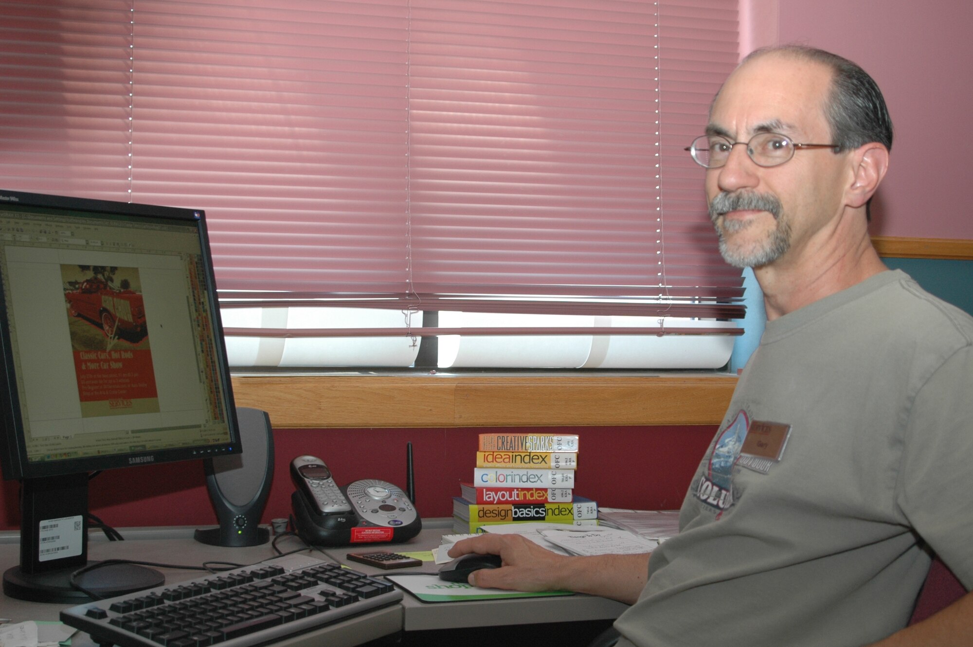 Gary Huffman, 341st Services Squadron graphic designer, poses at his computer.
 Mr. Huffman won three Air Force-level marketing awards for 2006. (U.S. Air Force photo / Airman 1st Class Emerald Ralston)