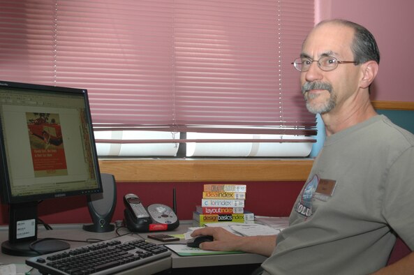 Gary Huffman, 341st Services Squadron graphic designer, poses at his computer.
 Mr. Huffman won three Air Force-level marketing awards for 2006. (U.S. Air Force photo / Airman 1st Class Emerald Ralston)