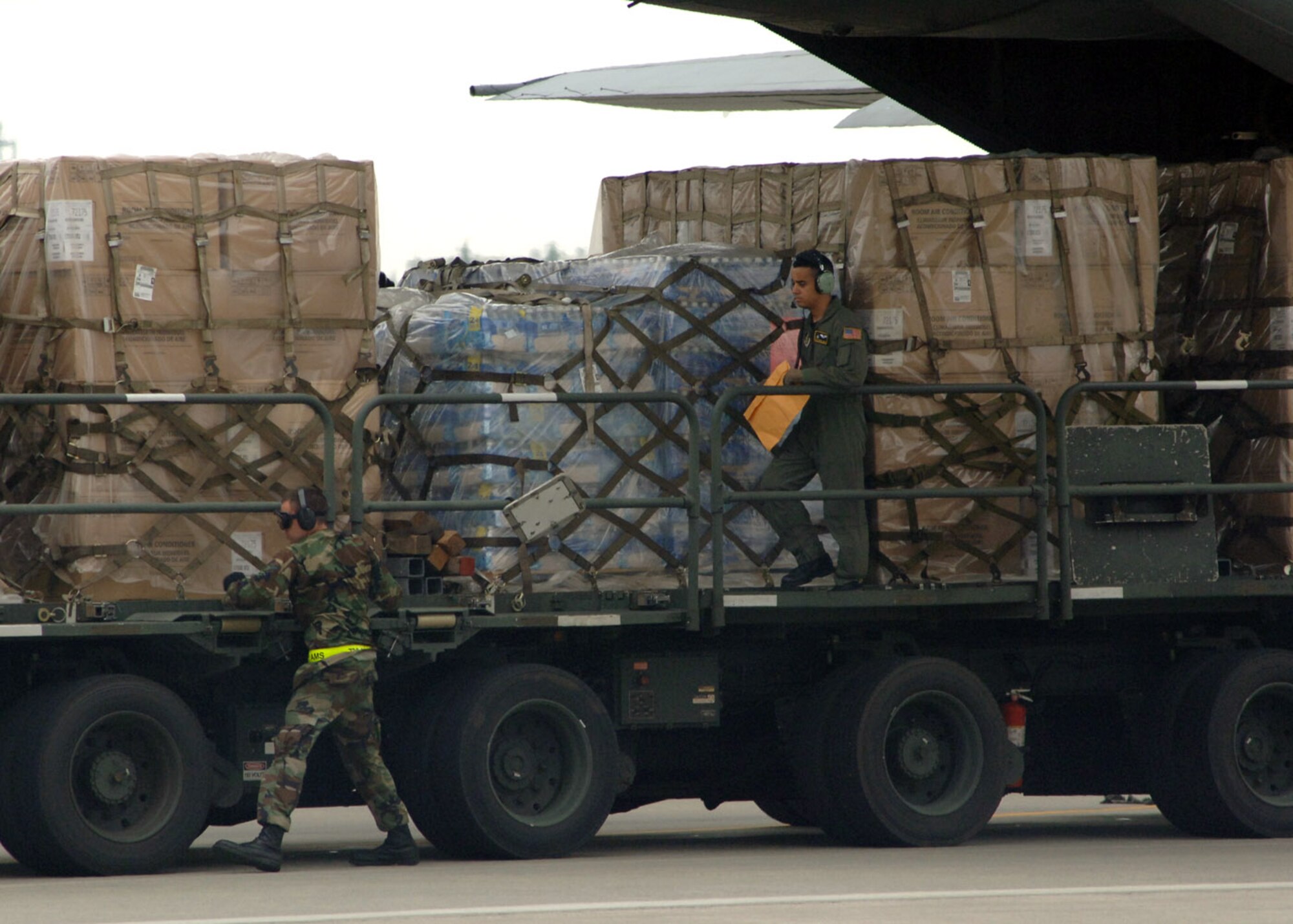 Airmen from the 374th Airlift Wing and 730th Air Mobility Squadron load supplies onto a C-130 Hercules for shipment to Niigata Airport July 18 at Yokota Air Base, Japan. The Airmen provided 10,000 pounds of water and 100 air-conditioning units to Japan after an earthquake hit one of Japan's largest city on the Sea of Japan. (U.S. Air Force photo/Senior Airman Veronica Pierce) 
