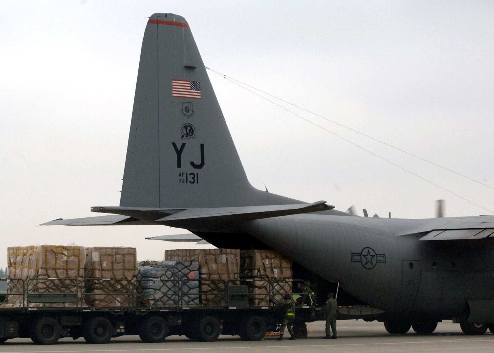 Airmen from the 374th Airlift Wing and 730th Air Mobility Suqadron load supplies onto a C-130 Hercules for shipment to Niigata Airport July 18 at Yokota Air Base, Japan. The Airmen provided 10,000 pounds of water and 100 air-conditioning units to Japan after an earthquake hit one of Japan's largest city on the Sea of Japan. (U.S. Air Force photo/Senior Airman Veronica Pierce) 
