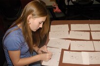 Jennifer Zimmerman works on a cartoon while accumulating hours for the Youth Employment Skills, or YES, scholarship program. The scholarship is available to all children who have a parent who is currently serving active duty for the Air Force. Jennifer, 14, is the daughter of Madeline and Master Sgt. Marlin Zimmerman of the 59th Medical Wing. (USAF photo by Tony Perez)                                