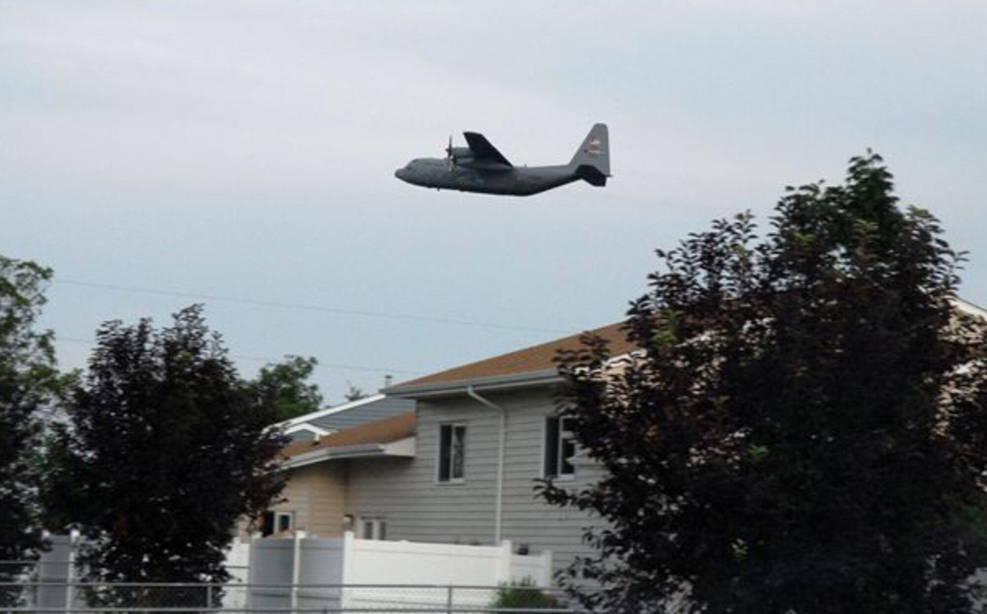MINOT AIR FORCE BASE, N.D. -- An Air Force Reserve C-130 from the 910th Airlift Wing, Youngstown, Ohio, flies over the base July 17 spraying a chemical called Trumpet to reduce the mosquito population here. It is the third time in as many years a C-130 has come here to spray for mosquitoes. (U.S. Air Force photo by Senior Master Sgt. Jeffrey Stark)