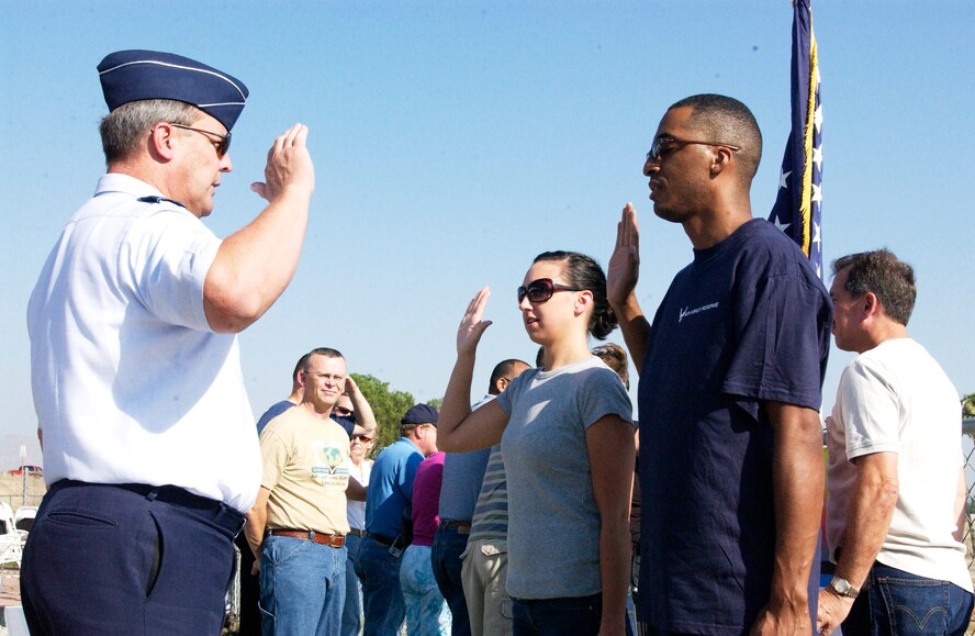 Maj. Gen. Robert Duignan, 4th Air Force commander, enlisted two new Airmen at Adams Go Kart track. The Raincross event is put on by 4th Air Force, March Air Reserve Base, with the trophy dinner hosted by the Greater Riverside Chambers of Commerce and held at the Riverside Convention Center. (U.S. Air Force photo by Amy Abbott) 
