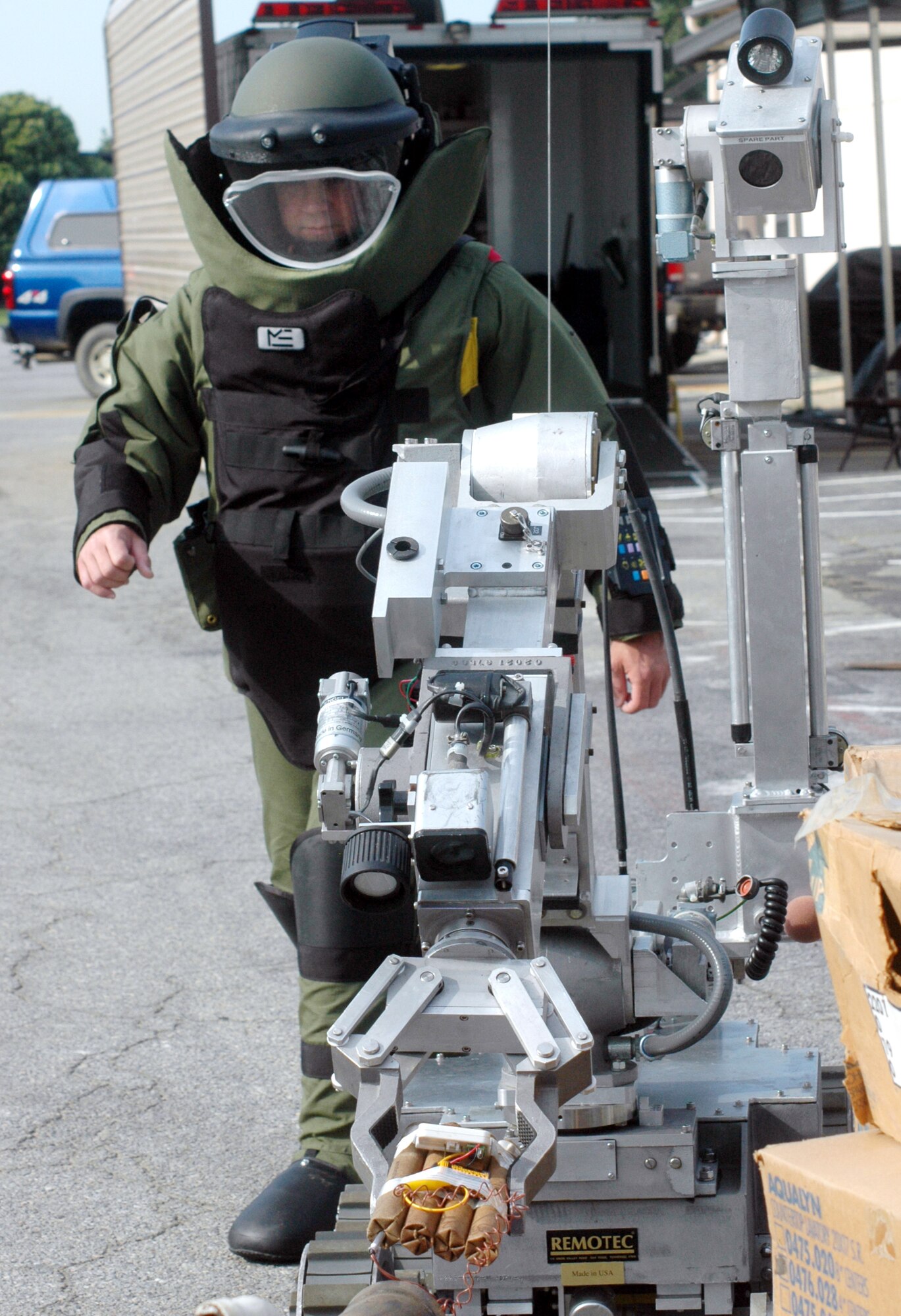 TSgt. Joseph Fletcher, dressed in an EOD 9 bomb suit, demonstrates  the Remotec Andros robot July 13. U. S. Air Force photo by Sue Sapp 