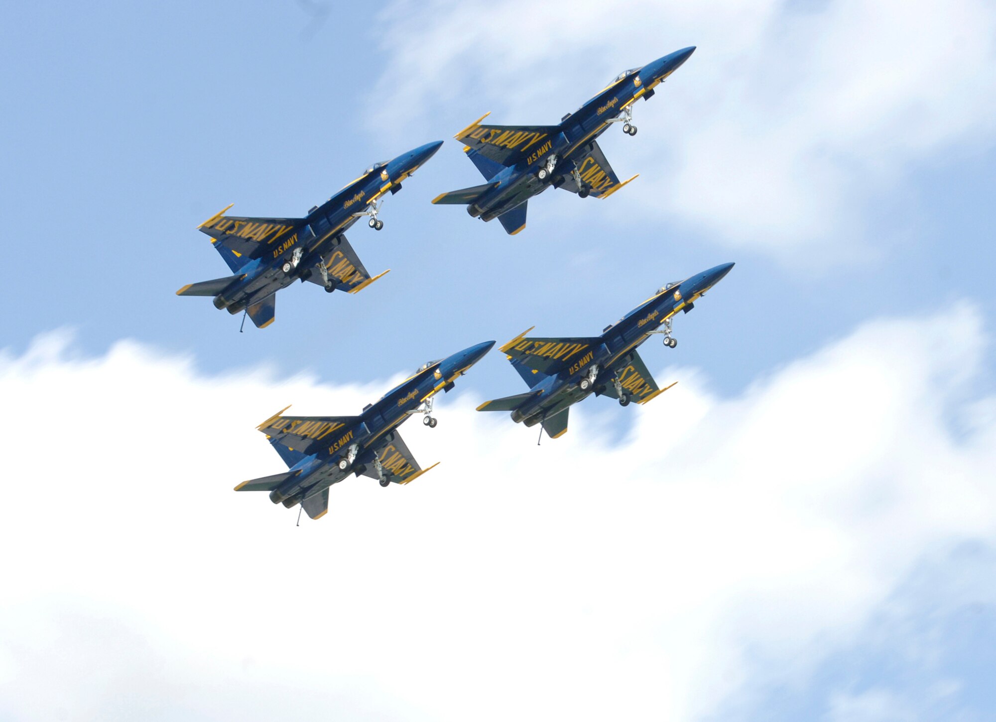 MCCONNELL AIR FORCE BASE, Kan. -- Four F/A-18 Hornets from Navy Blue Angels aerial demonstration team perform a stacked pass maneuver July 14 at McConnell’s Open House. Approximately 101,891 people attended this year’s Open House event, which took place at McConnell July 14-15. (Photo by Airman Justin Shelton)