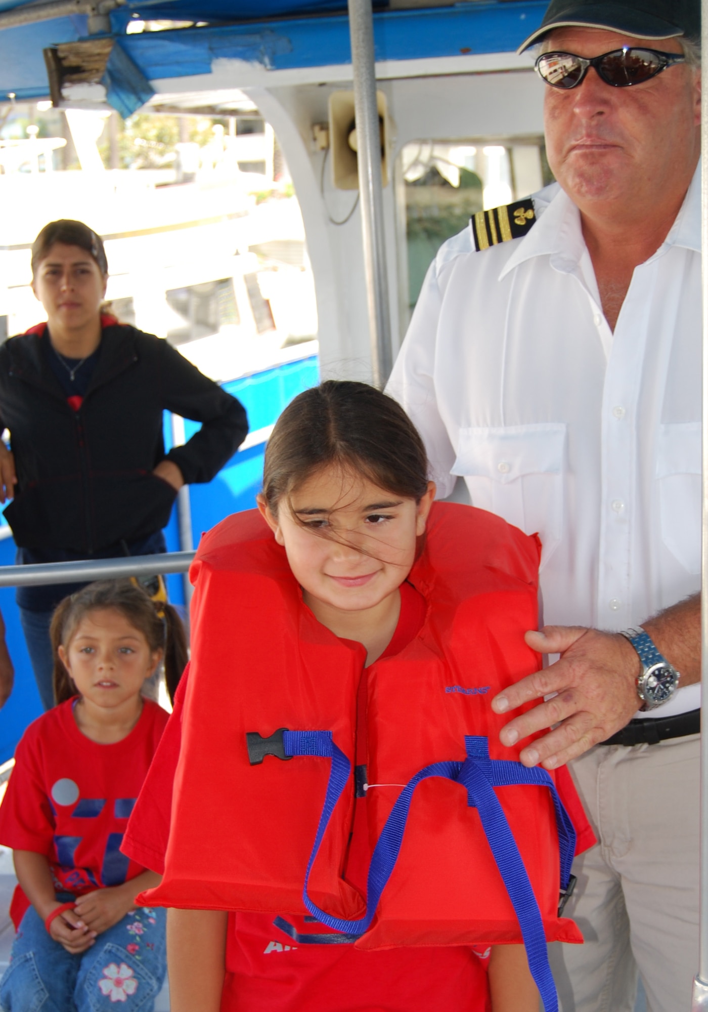 Summer campers received a safety briefing about the proper wearing of a life jacket prior to getting underway on a tour of the Los Angeles Harbor, July 11. The harbor cruise field trip was part of Youth Services’ LA Experience Summer Camp. The summer program runs through August and includes trips to museums, beaches and a mud park. (Photo by Paul Testerman)