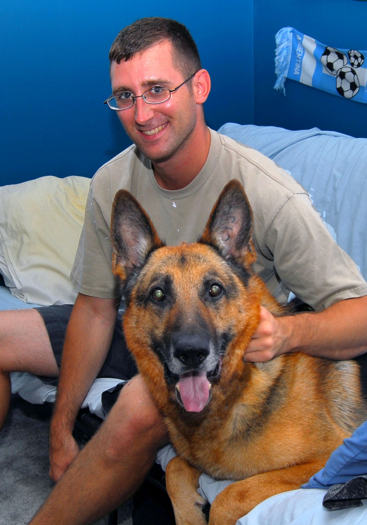 Staff Sgt. Morgan Maul and Ajax, a recently retired military working dog that Sergeant Maul has adopted.  Sergeant Maul is a 23rd Security Forces Squadron military working dog handler at Moody Air Force Base, Ga.  (U.S. Air Force photo/Tech. Sgt. Parker Gyokeres)