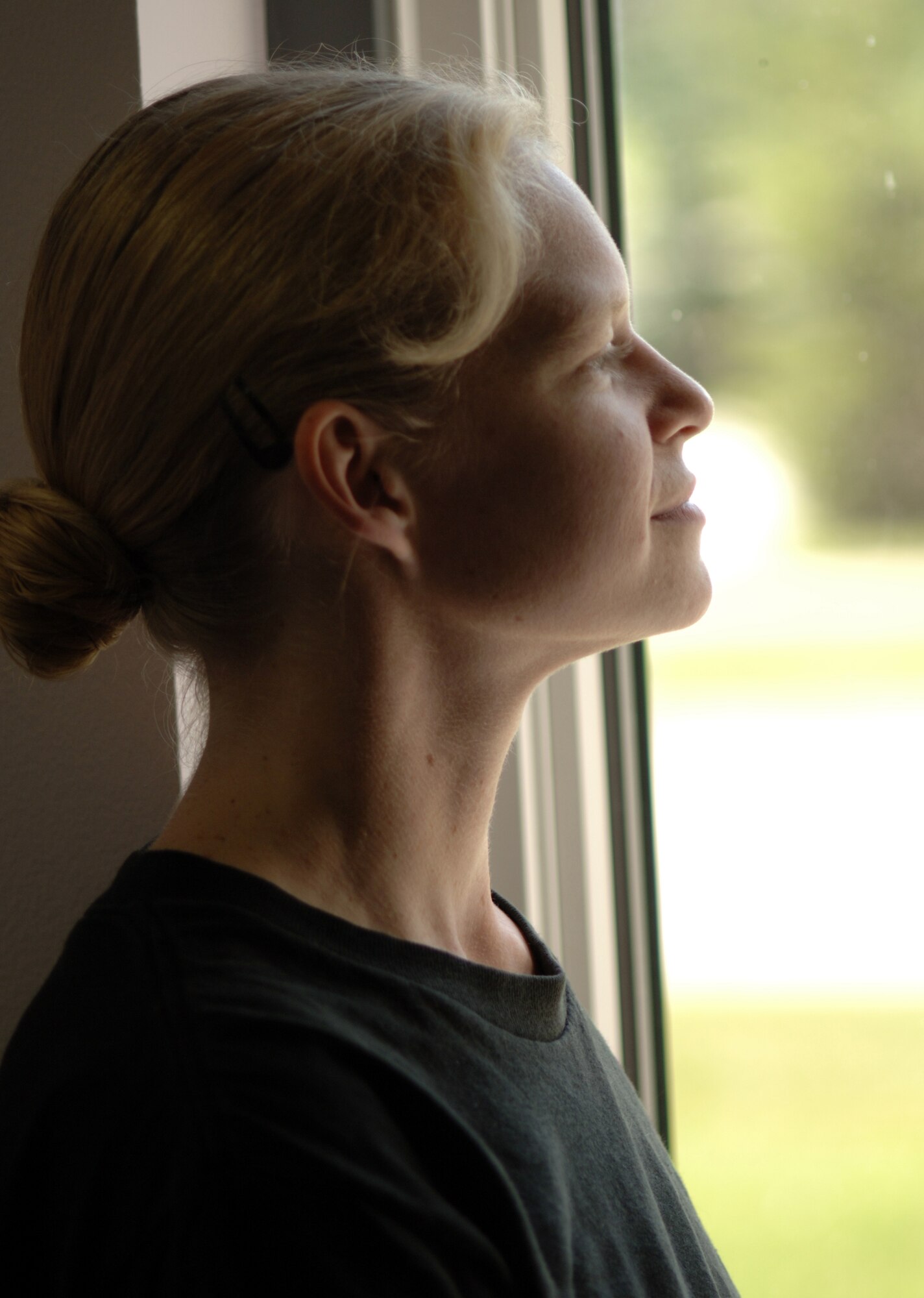 GRAND FORKS AIR FORCE BASE, N.D. -- 1st Lt. Cara Ebner, 319th Mission Support and Services Squadron, looks out a window at the Escape Zone here. Lieutenant Ebner recently published her first novel ?Blood Cult? and is currently working on the sequel as well as two other novels. (U.S. Air Force photo/Senior Airman J. Paul Croxon)