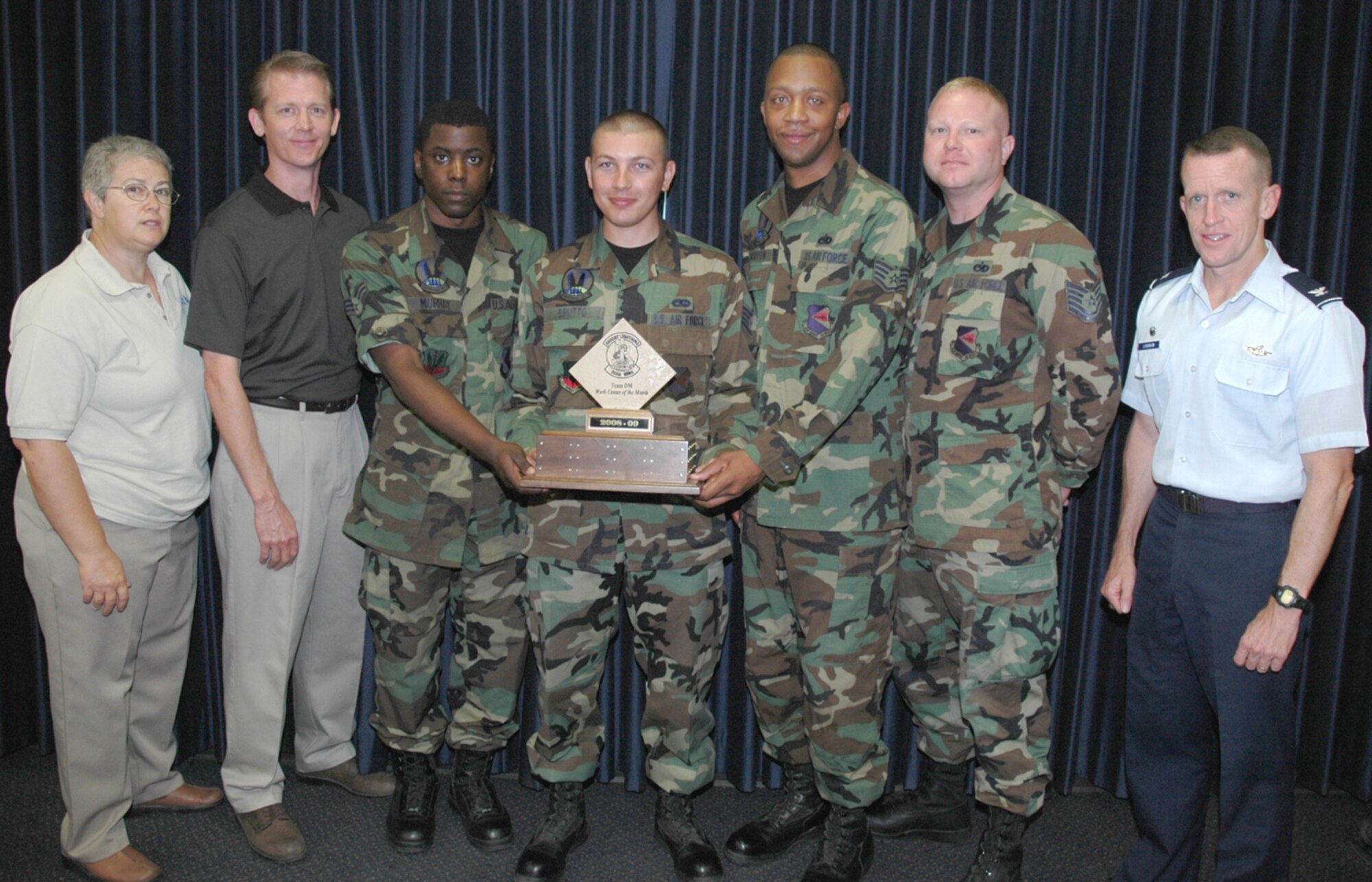 Col. Kent Laughbaum (far right), 355th Fighter Wing Commander, and Karen Halstead, president of the Air Force Association’s local chapter, pose with members of D-M’s Air Force Repair Enhancement Program office and their AFA Workcenter of the Month award. (U.S. Air Force photo/2nd Lt. Mary J. Pekas)
