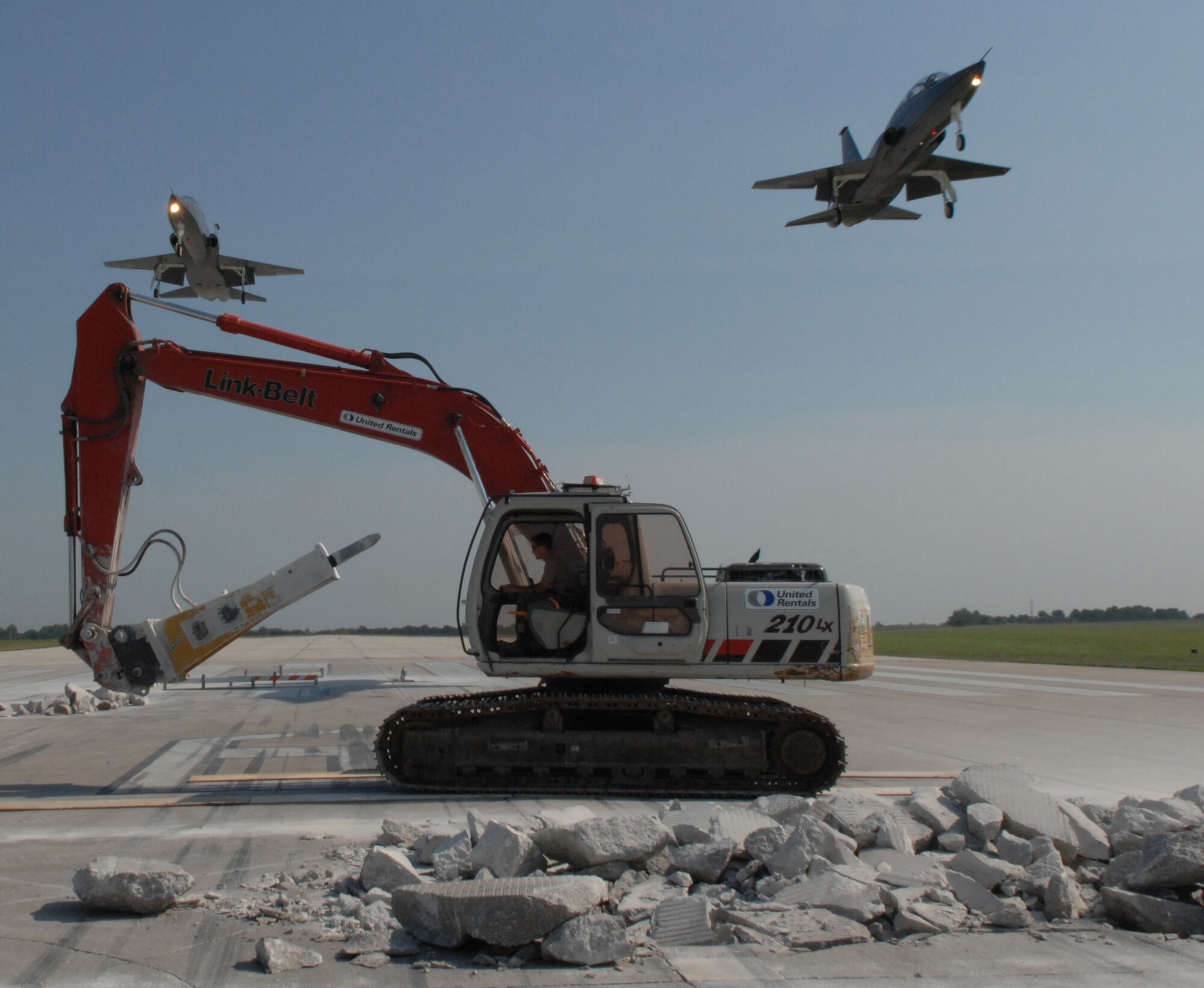 WHITEMAN AIR FORCE BASE, Mo. -- Members of the 823rd RED HORSE Squadron continue to repair runway 19 as two T-38 Talons fly overhead. (U.S. Air Force photo/Staff Sgt. Jason Barebo)