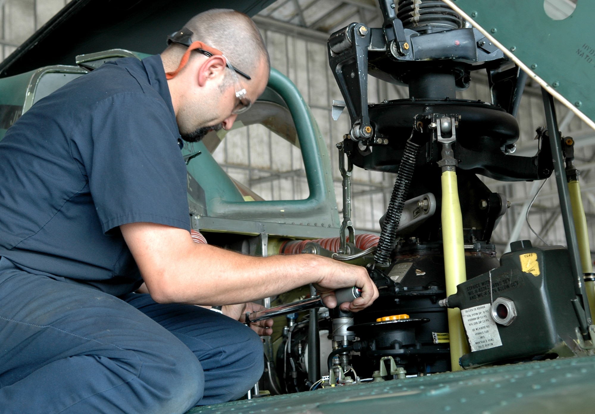 FAIRCHILD AIR FORCE BASE, Wash. -- Billy Harp, airframe powerplant general mechanic, checks the torque on the transmission of a UH-1N Huey during a vibration check July 17. Mr. Harp is a mechanic that helps maintain the 36th Rescue Flight’s fleet of helicopters that support local search and rescue operations, as well as the 336th survival school. (U.S. Air Force photo/ Tech. Sgt. Larry W. Carpenter Jr.)